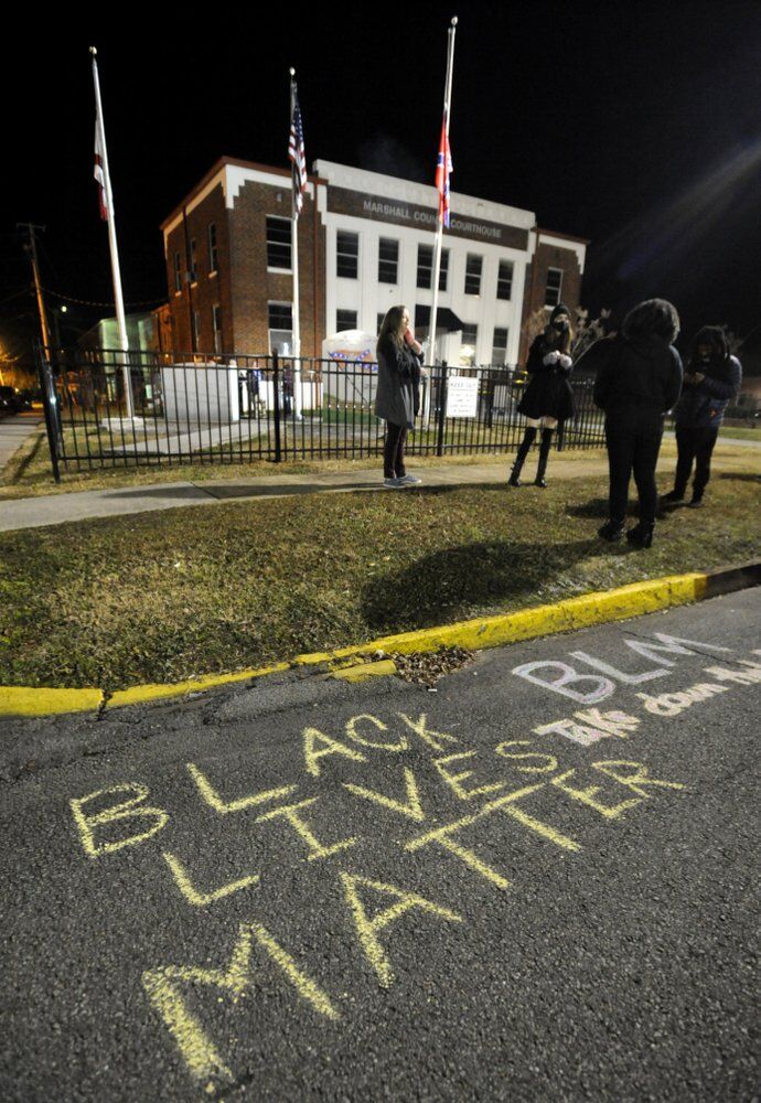 Demonstrators gather outside the Marshall County Courthouse in Albertville, Alabama